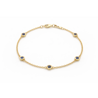 14ct gold bezel sapphire bracelet featuring a vibrant blue sapphire gemstone set in a sleek gold design.