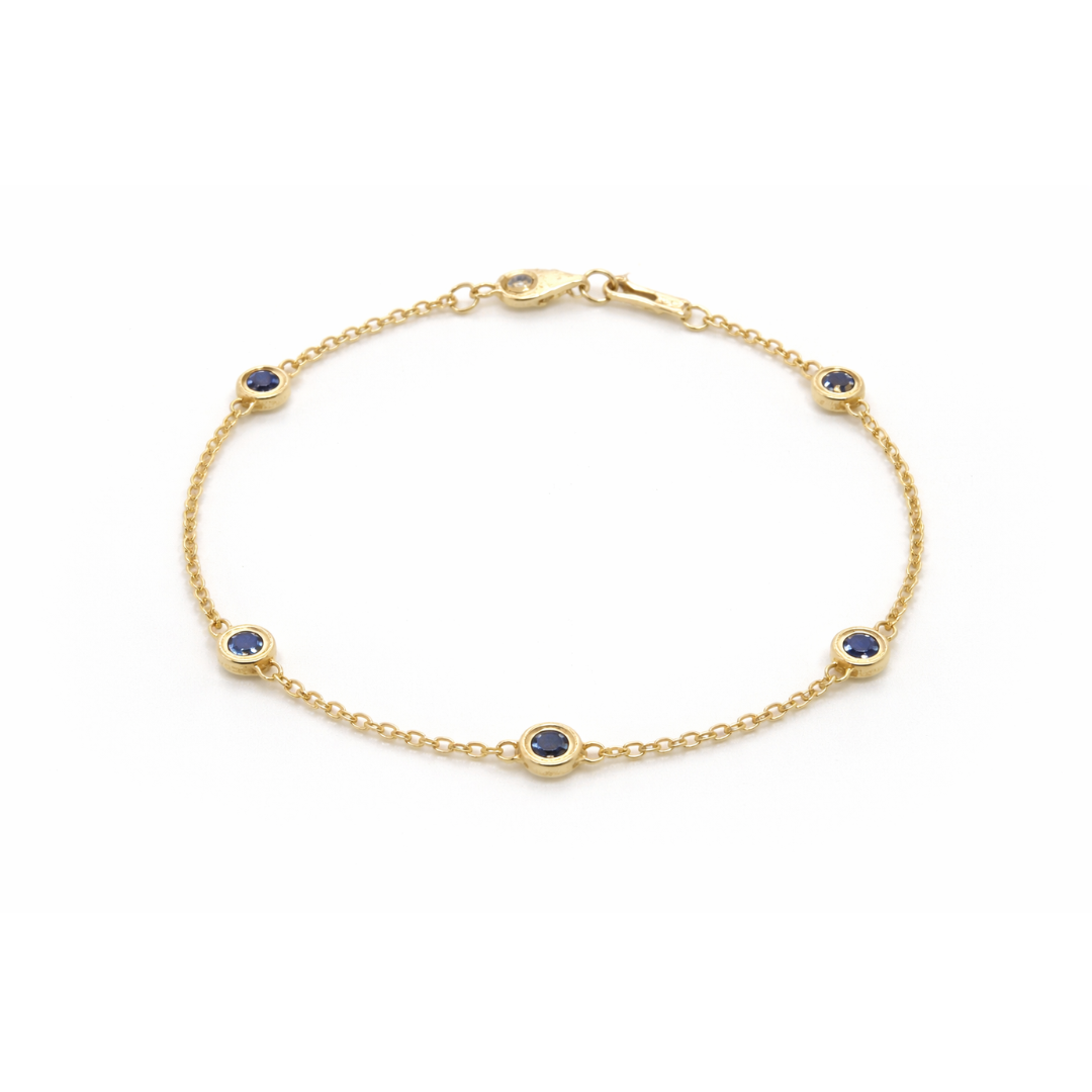 14ct gold bezel sapphire bracelet featuring a vibrant blue sapphire gemstone set in a sleek gold design.