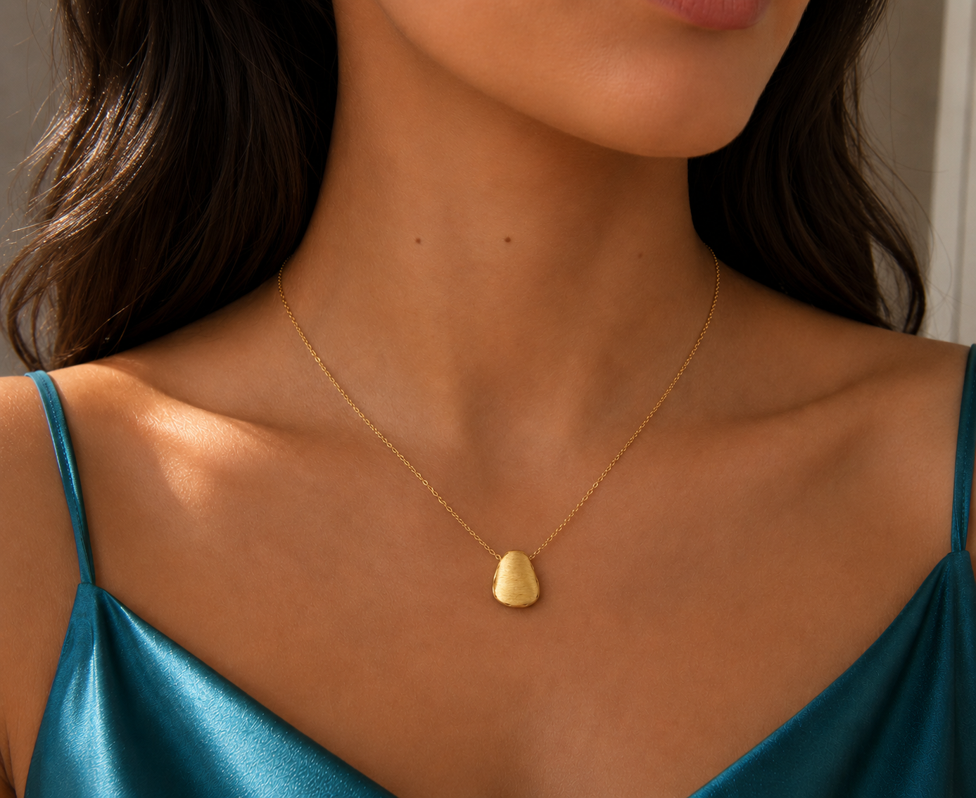 14ct brushed gold nugget pendant on a delicate necklace from Appleby Jewellers Dublin, showcasing textured gold with a modern design.