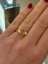 Tangerine Sapphire diamond ring by Appleby Jewellers Dublin featuring a vibrant orange sapphire set in a sleek gold band.