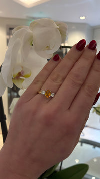 Tangerine sapphire diamond ring by Appleby Jewellers Dublin featuring a vibrant orange sapphire gemstone in a elegant silver setting.