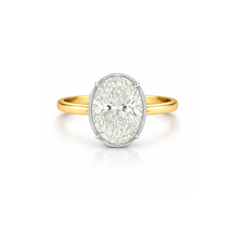 Oval diamond bezel ring from Appleby Jewellers Dublin, showcasing a 2.20ct central diamond set in a sleek gold band.