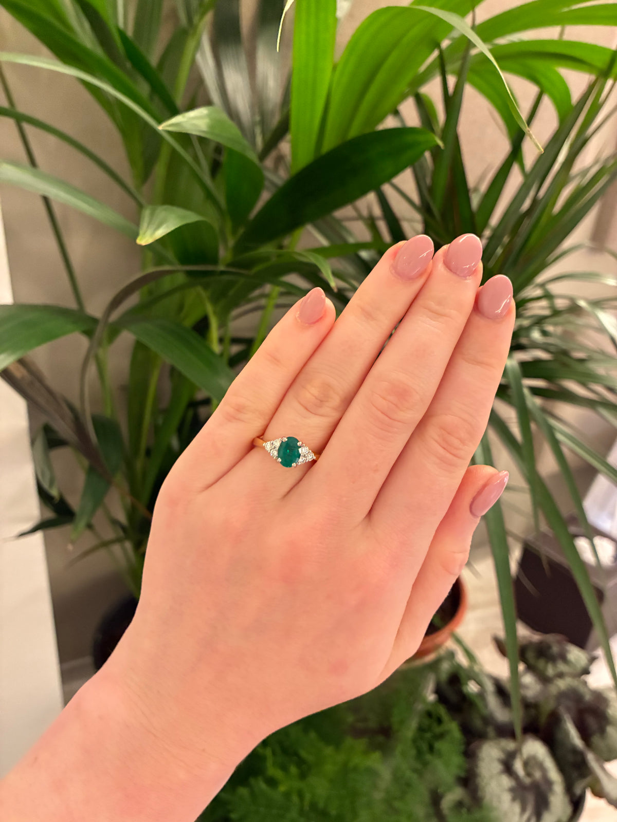 Elegant emerald and diamond three-stone ring by Appleby Jewellers Dublin, showcasing sparkling gemstones and intricate band details.