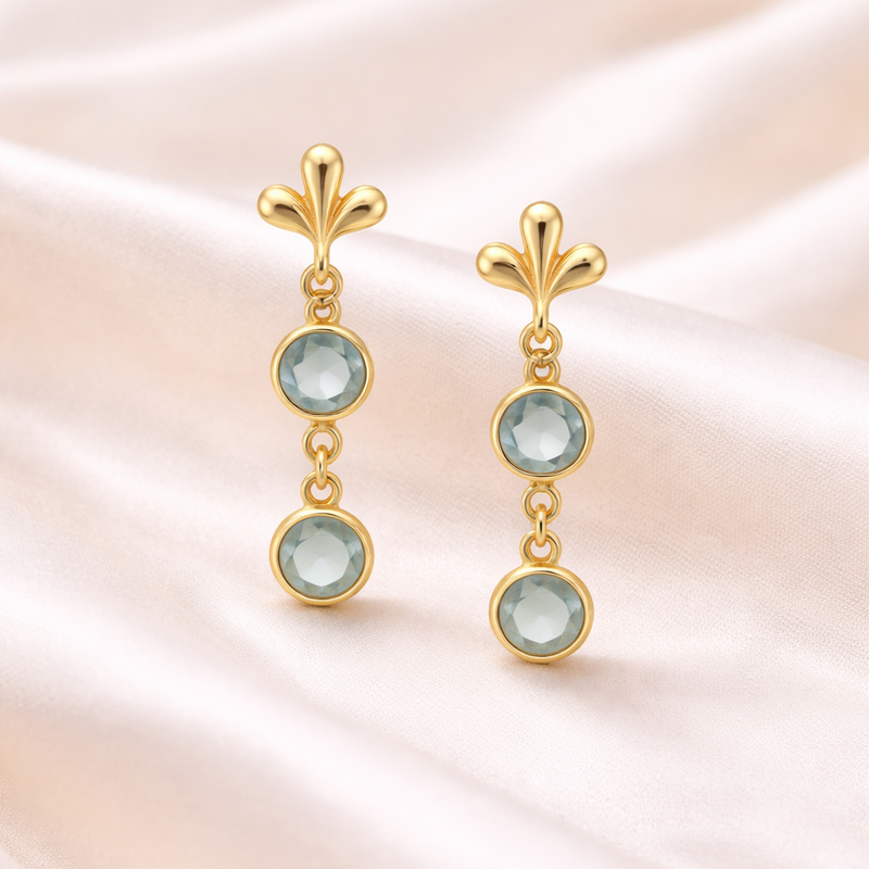 Elegant gold drop earrings with blue topaz and aquamarine accents, crafted by Appleby Jewellers Dublin.