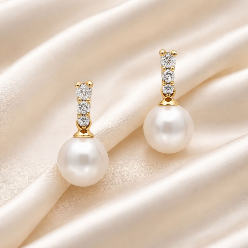 Elegant 18ct gold drop earrings with diamonds and pearls, featuring 0.20ct of sparkling diamonds and classic pearl accents.