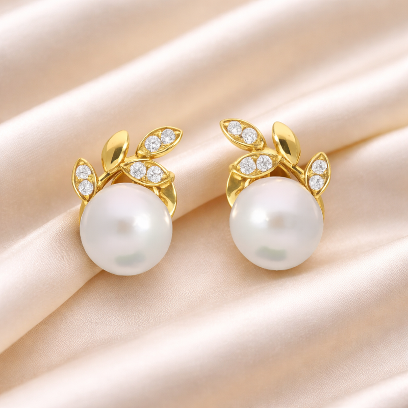 Elegant pearl and gold diamond stud earrings by Appleby Jewellers Dublin, showcasing classic and sophisticated jewelry design.