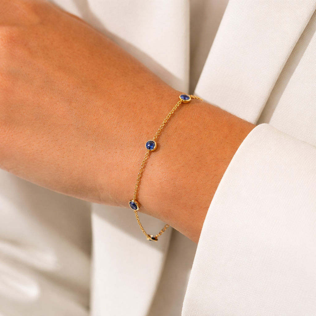 Elegant 14ct gold bezel sapphire bracelet worn on wrist, showcasing fine craftsmanship by Appleby Jewellers Dublin.