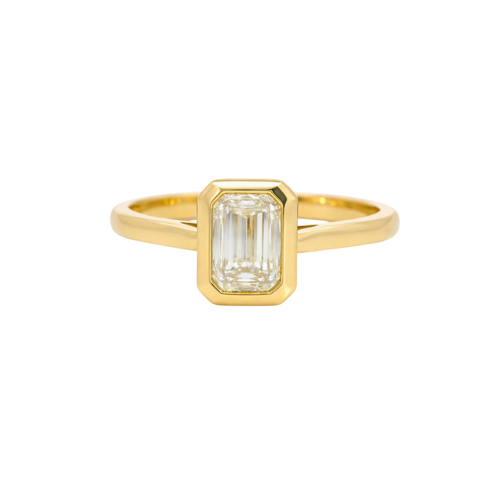 Emerald cut bezel diamond ring by Appleby Jewellers Dublin, showcasing a sleek, modern design with a central emerald cut diamond.