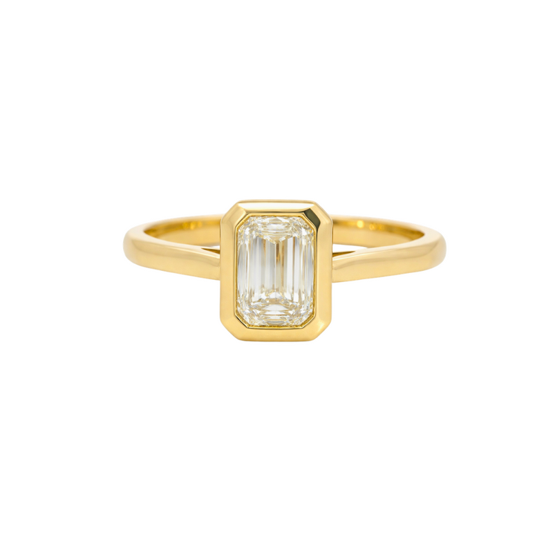 Emerald cut bezel diamond ring by Appleby Jewellers Dublin, showcasing a sleek, modern design with a central emerald cut diamond.