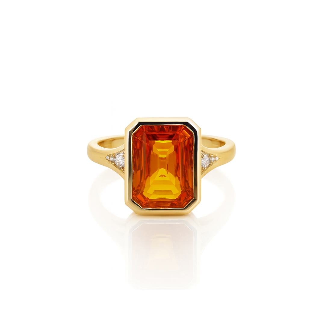 Mandarin sapphire and diamond ring from Appleby Jewellers Dublin featuring a vibrant orange gemstone and sparkling diamonds in a gold setting.