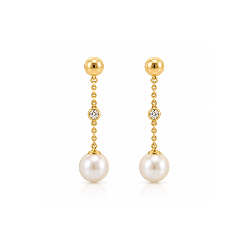 Pearl and diamond drop earrings with gold settings, featuring elegant teardrop-shaped pearls and sparkling diamonds.