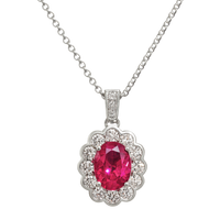 Gold Ruby and diamond cluster pendant necklace by Appleby Jewellers Dublin featuring a sparkling gemstone design.