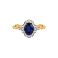 Gold ring with a blue gemstone and diamond accents on a white background