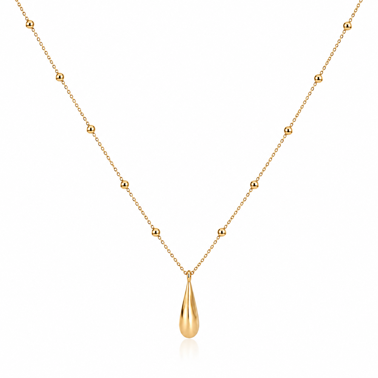 A delicate gold necklace featuring a fine chain with evenly spaced small bead accents and a polished teardrop-shaped pendant, displayed on a clean white background.