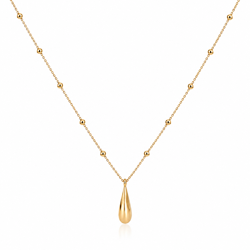 A delicate gold necklace featuring a fine chain with evenly spaced small bead accents and a polished teardrop-shaped pendant, displayed on a clean white background.