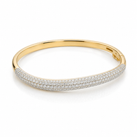 Elegant wave-shaped diamond bangle by Appleby Jewellers Dublin, featuring sparkling diamonds and a sleek gold finish.