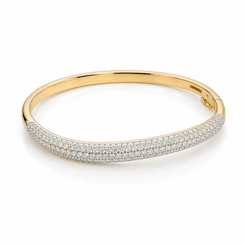 Elegant wave-shaped diamond bangle by Appleby Jewellers Dublin, featuring sparkling diamonds and a sleek gold finish.
