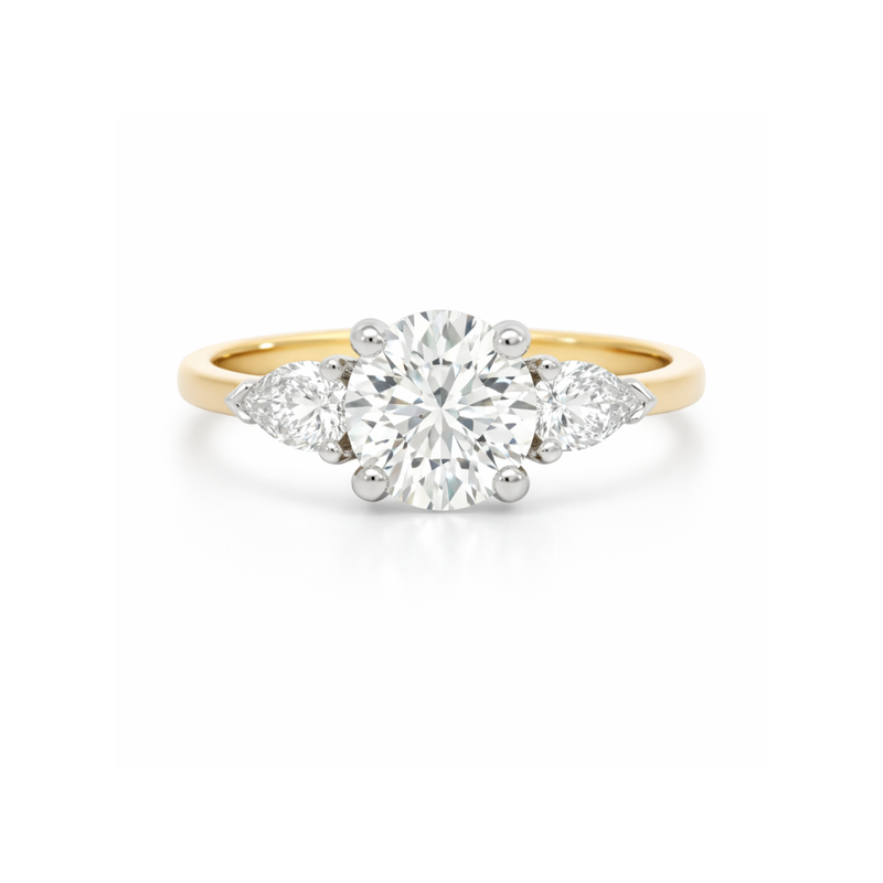 Elegant diamond ring featuring a 1.61ct round brilliant center stone with pear-shaped side diamonds by Appleby Jewellers Dublin.