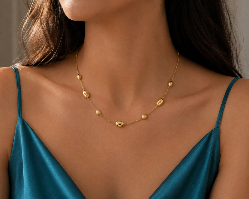 Yellow gold bead necklace with round gold beads, crafted by Appleby Jewellers Dublin, showcasing a stylish and elegant jewelry piece.