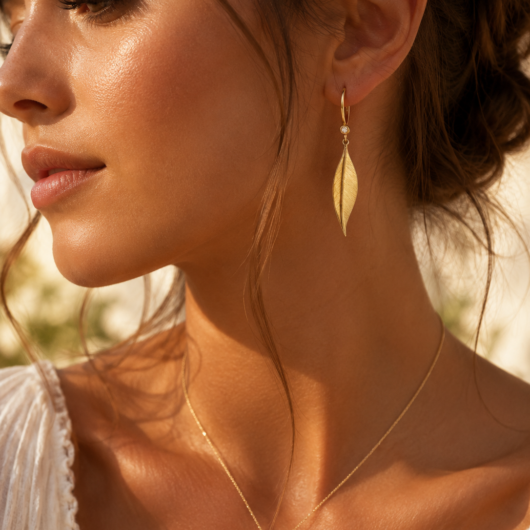 Gold leaf earrings by Appleby Jewellers Dublin, elegant dangle earrings with intricate leaf design and gold finish.