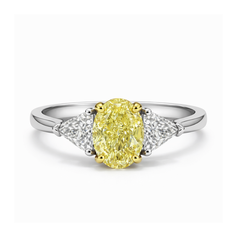 Ring with a yellow diamond and two smaller diamonds on a white background